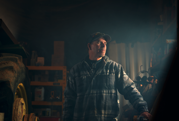 Man next to a tractor in a workshop